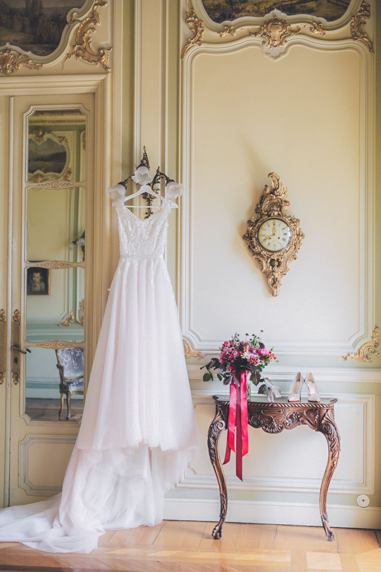 blush wedding gown displayed in an elegant French-style at Lisboa Pestana palace. Captured by a destination wedding photographer in Portugal