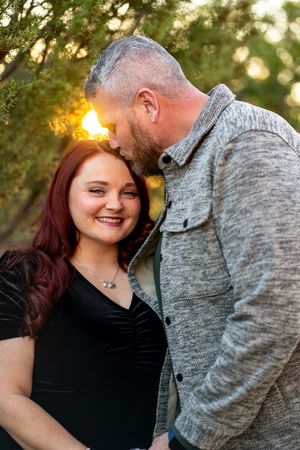 Romantic sunset portrait session in a natural outdoor setting.