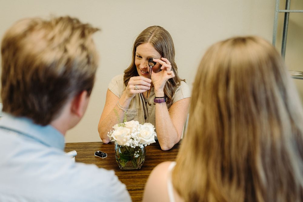 An emotional reaction captured during what appears to be a special moment at a table indoors.