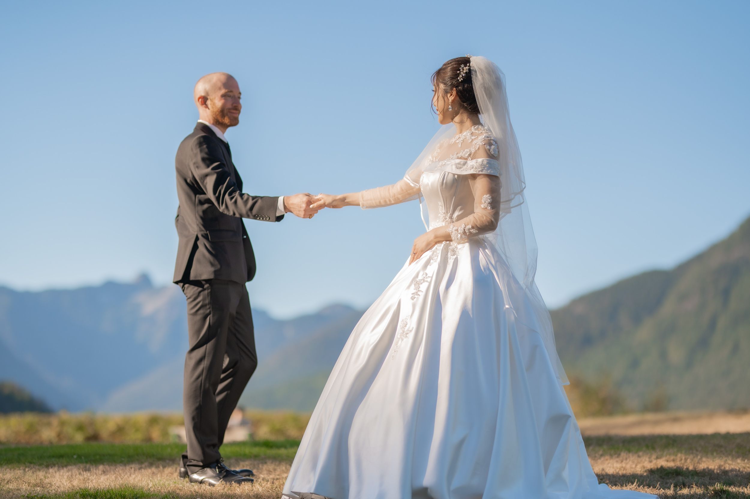 A scenic mountain wedding ceremony with a couple exchanging vows.