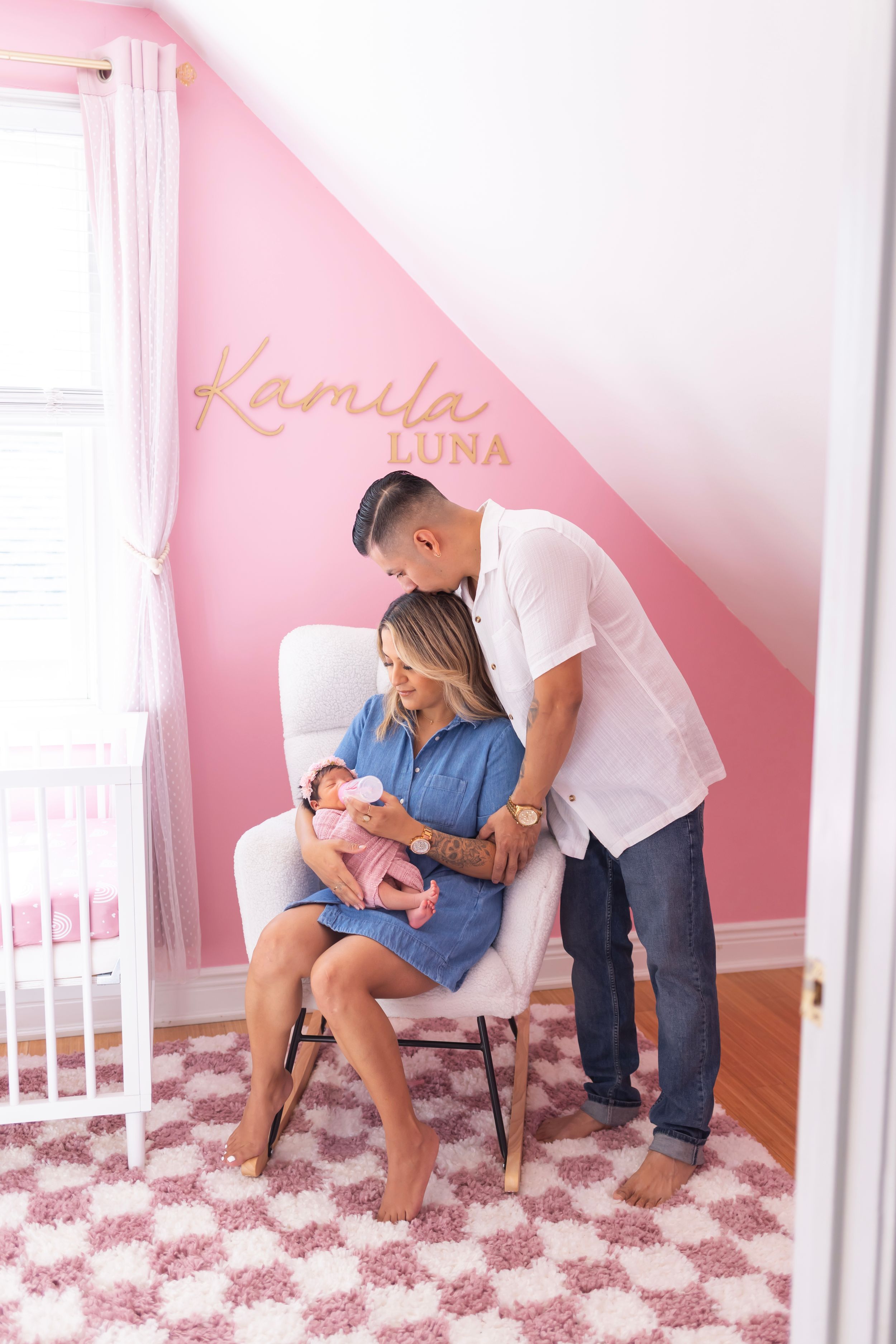 Three connected photos show a family admiring a newborn baby in a pink nursery with floral rug and white crib.