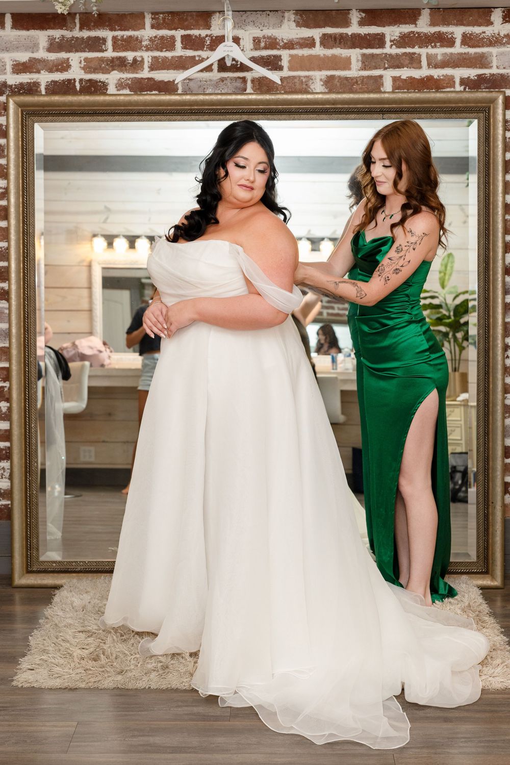 A series of photos showing a bride in a white gown being helped with her dress by bridesmaids in emerald green dresses.