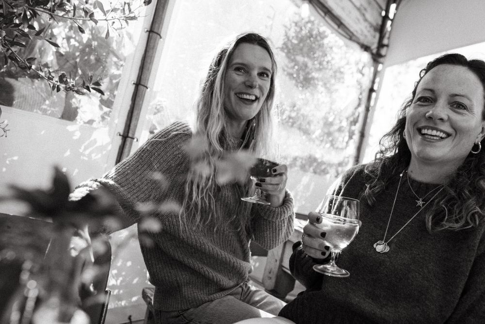 A series of black and white candid photos showing people laughing and enjoying themselves at a social gathering.