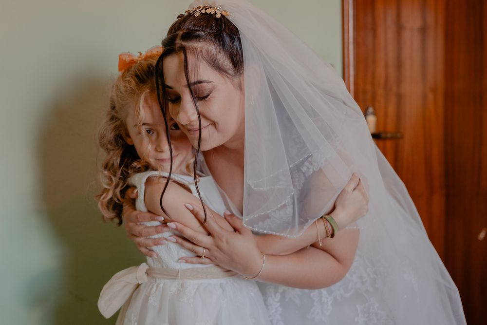 Intimate wedding preparation moment captured in soft, natural lighting.