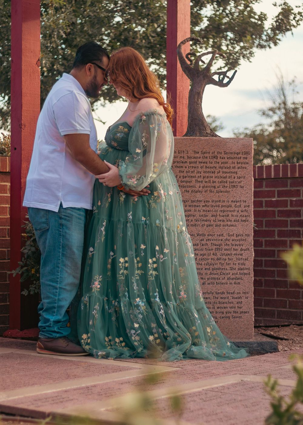 A couple in matching turquoise and white outfits share an intimate moment during their outdoor photo session.