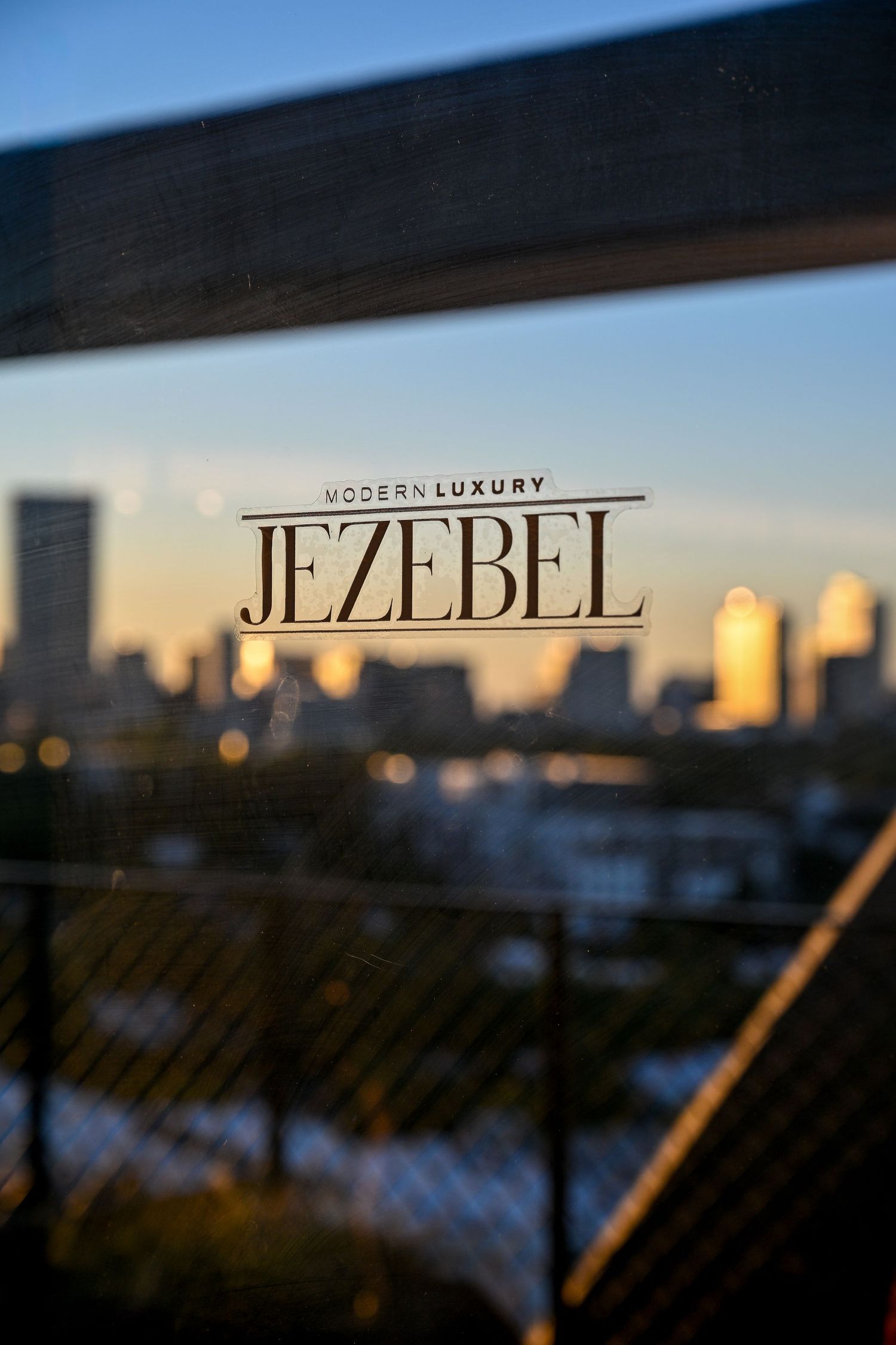 Blurry text reading 'JEZEBEL' appears against a sunset sky in a series of progressive focus shots.