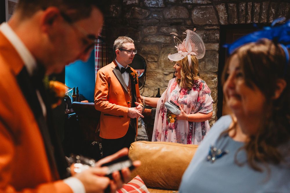 Candid shots of event attendees interacting in a stone-walled venue.