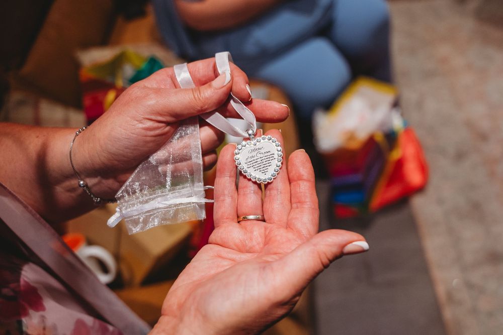Close-up shots of hands holding small decorative items during an event.
