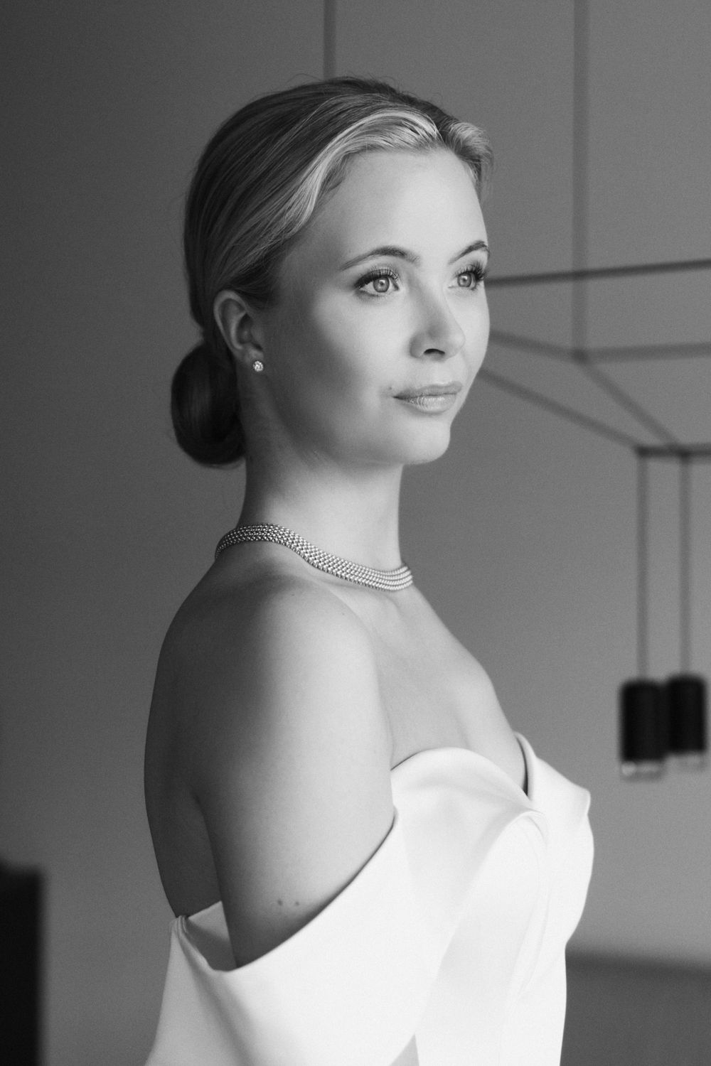 Black and white bridal portraits with dramatic lighting and elegant jewelry.