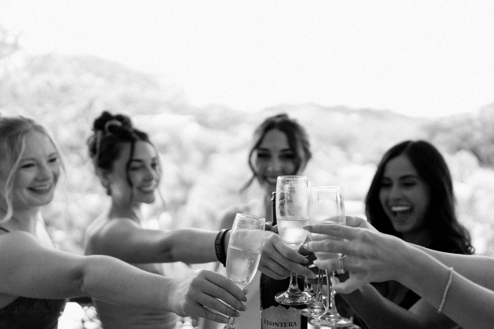 Bride making a toast with her friends after they finish the getting ready photos