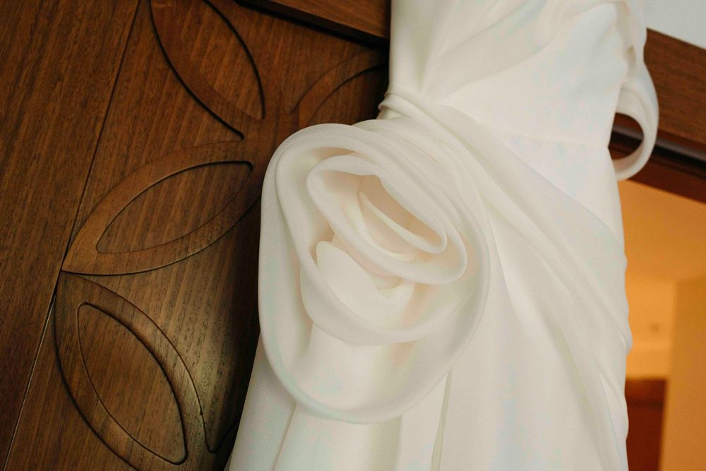 the wedding dress close up hanging and showing the beautiful details on the side