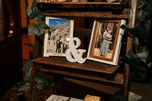 Vintage-style wooden shelving unit decorated with wedding photos and decor elements.