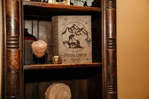 Rustic wooden shelving unit with vintage decor and antique items on display.