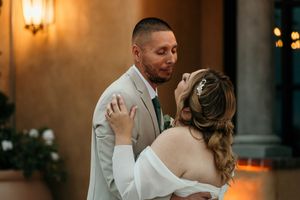 Romantic first dance at wedding reception with warm ambient lighting.