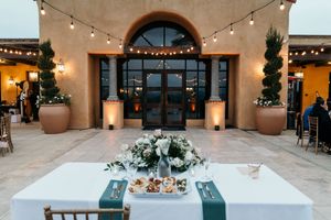 Mediterranean-style wedding venue with string lights and archways creating a romantic evening ambiance.
