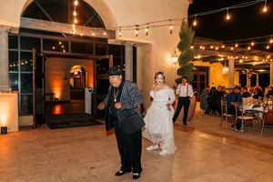 Wedding reception hall with string lights and arched doorways creating a romantic atmosphere.