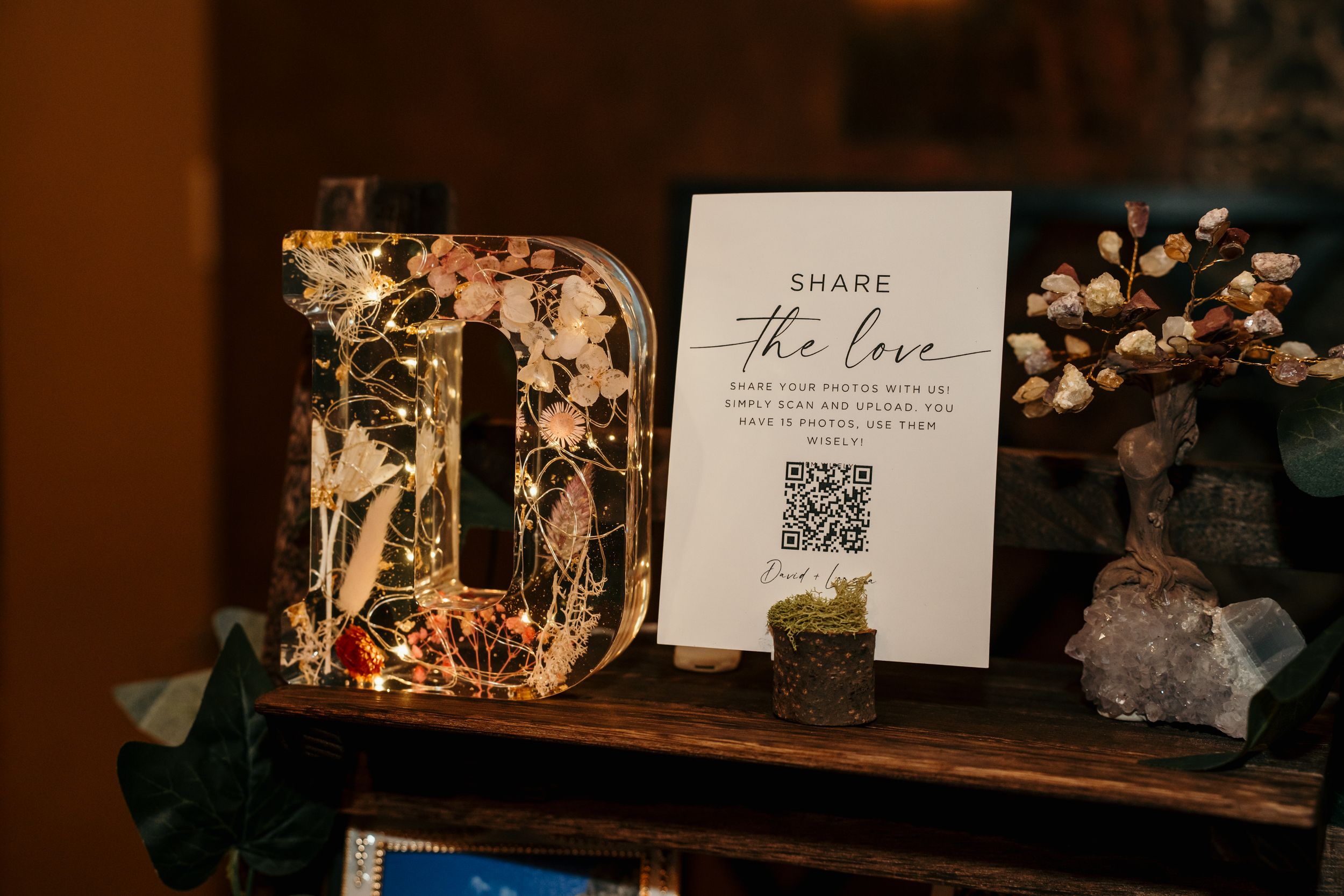 Rustic wooden shelves display wedding decor items and memorabilia in warm lighting.