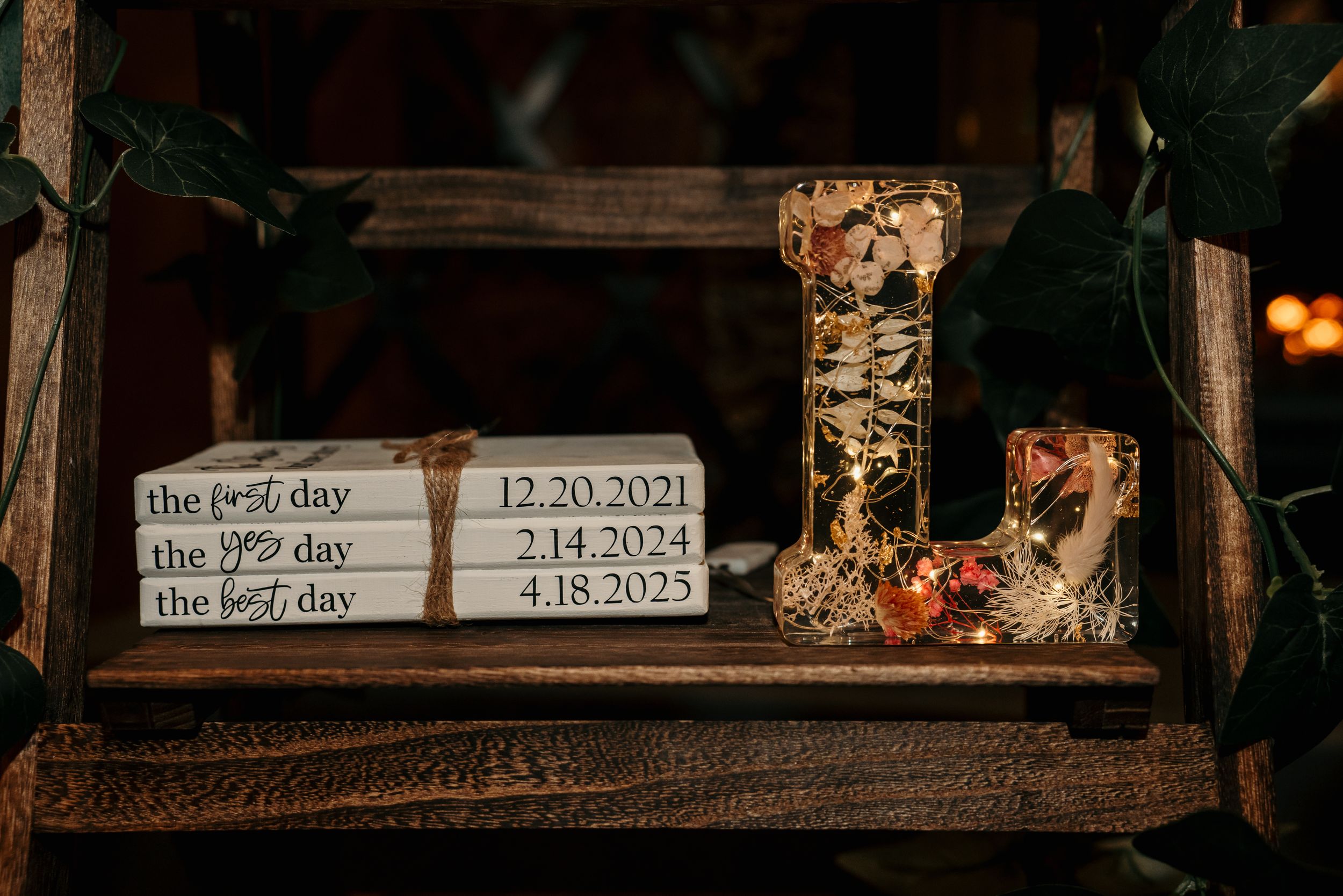 Three dates displayed on a rustic wooden shelf with decorative items and signage.