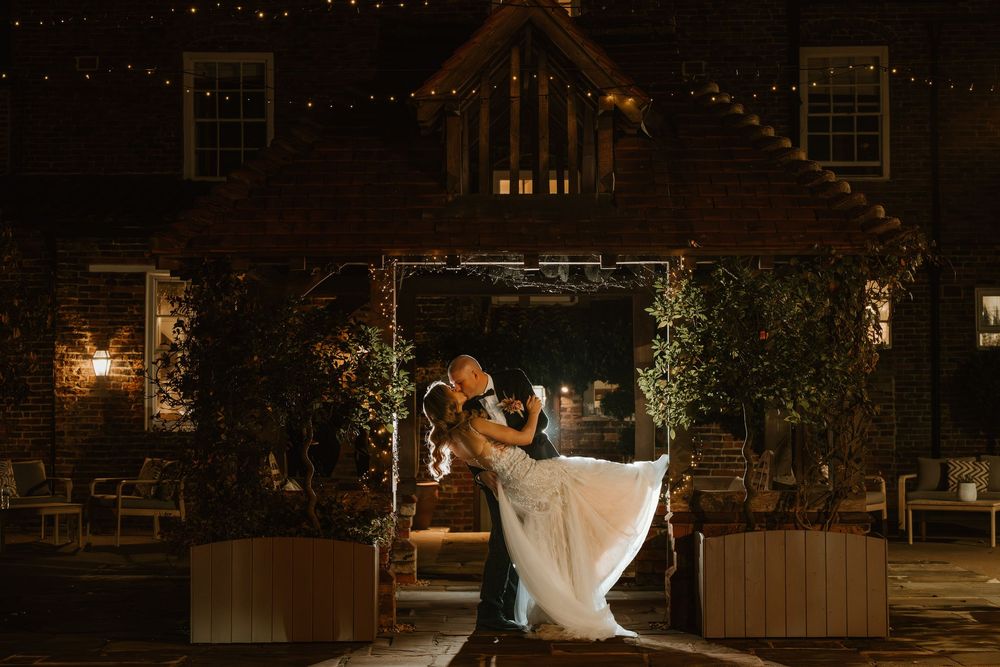 A romantic nighttime wedding photo series showing a couple in various outdoor poses illuminated by warm lighting.