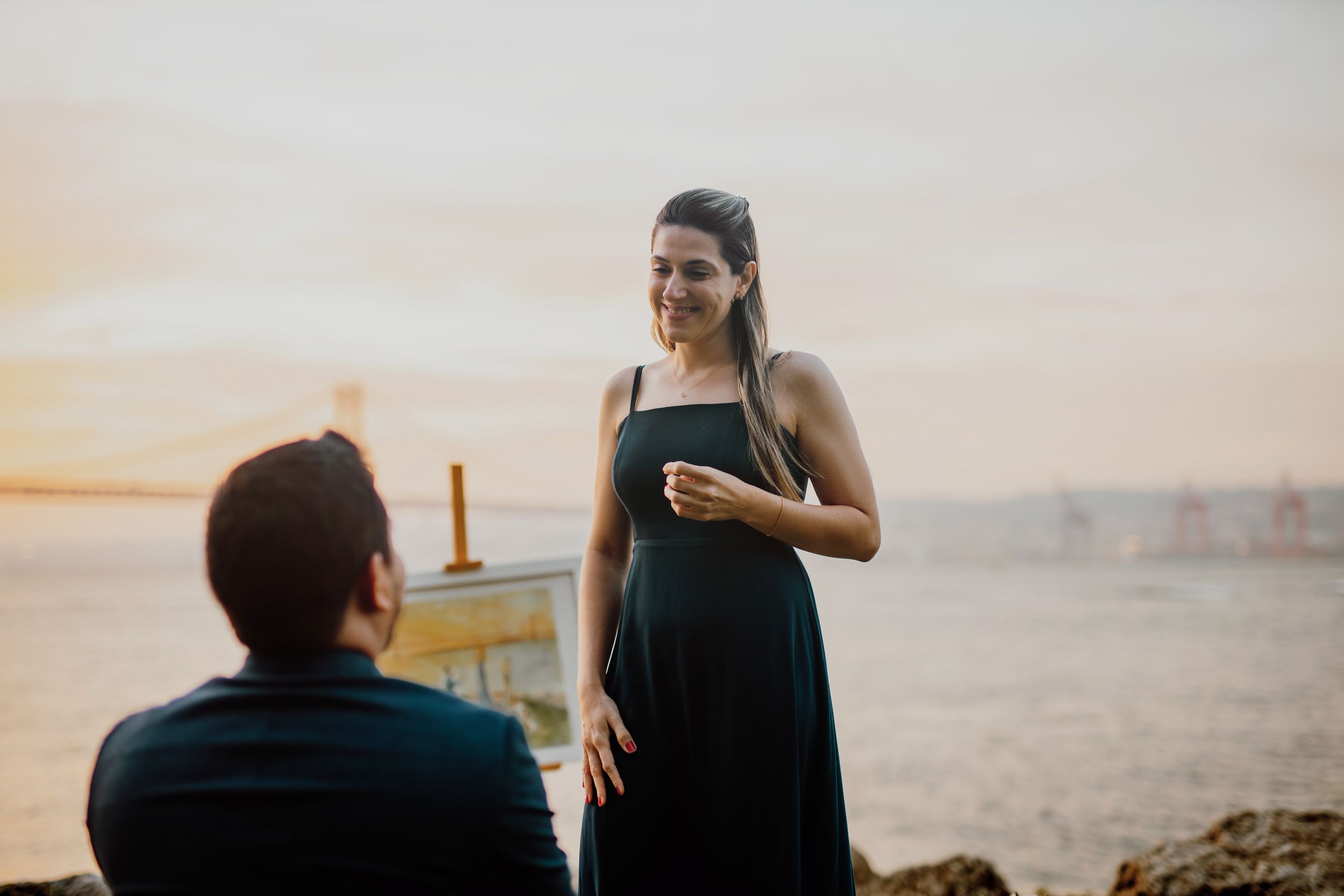 A series of beach engagement photos showing a couple in romantic poses during sunset by the ocean.