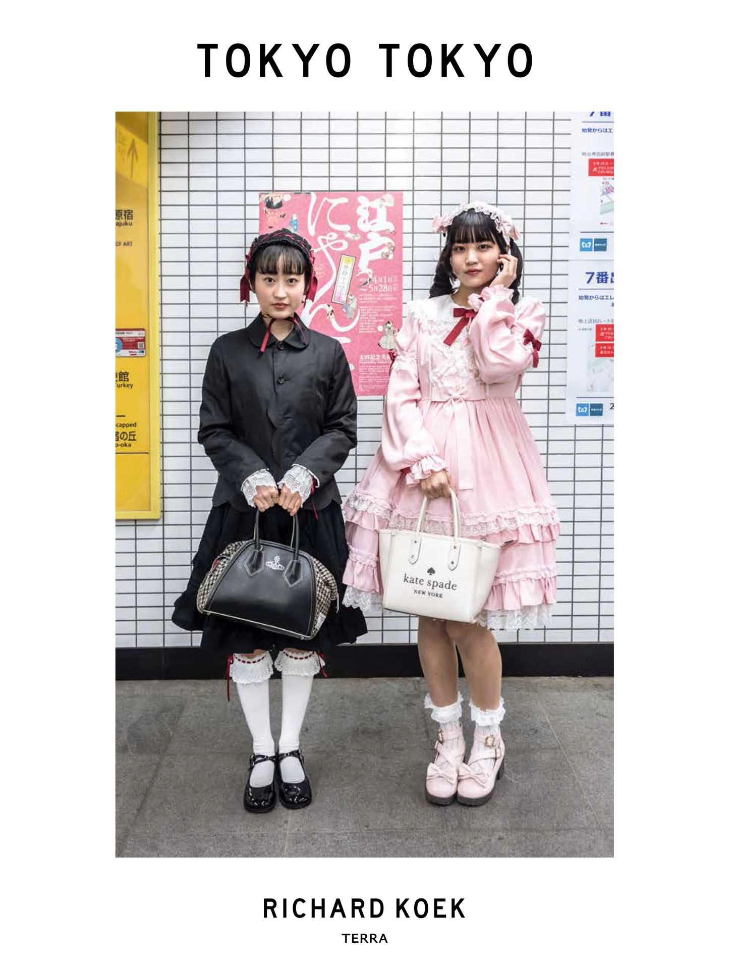 Two people in contrasting black and pink fashion styles standing against tiled wall with posters.
