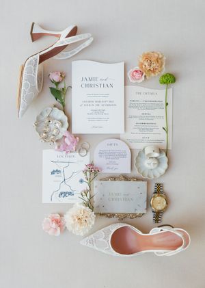 Wedding stationery suite with floral details and ribbons in soft pink tones.
