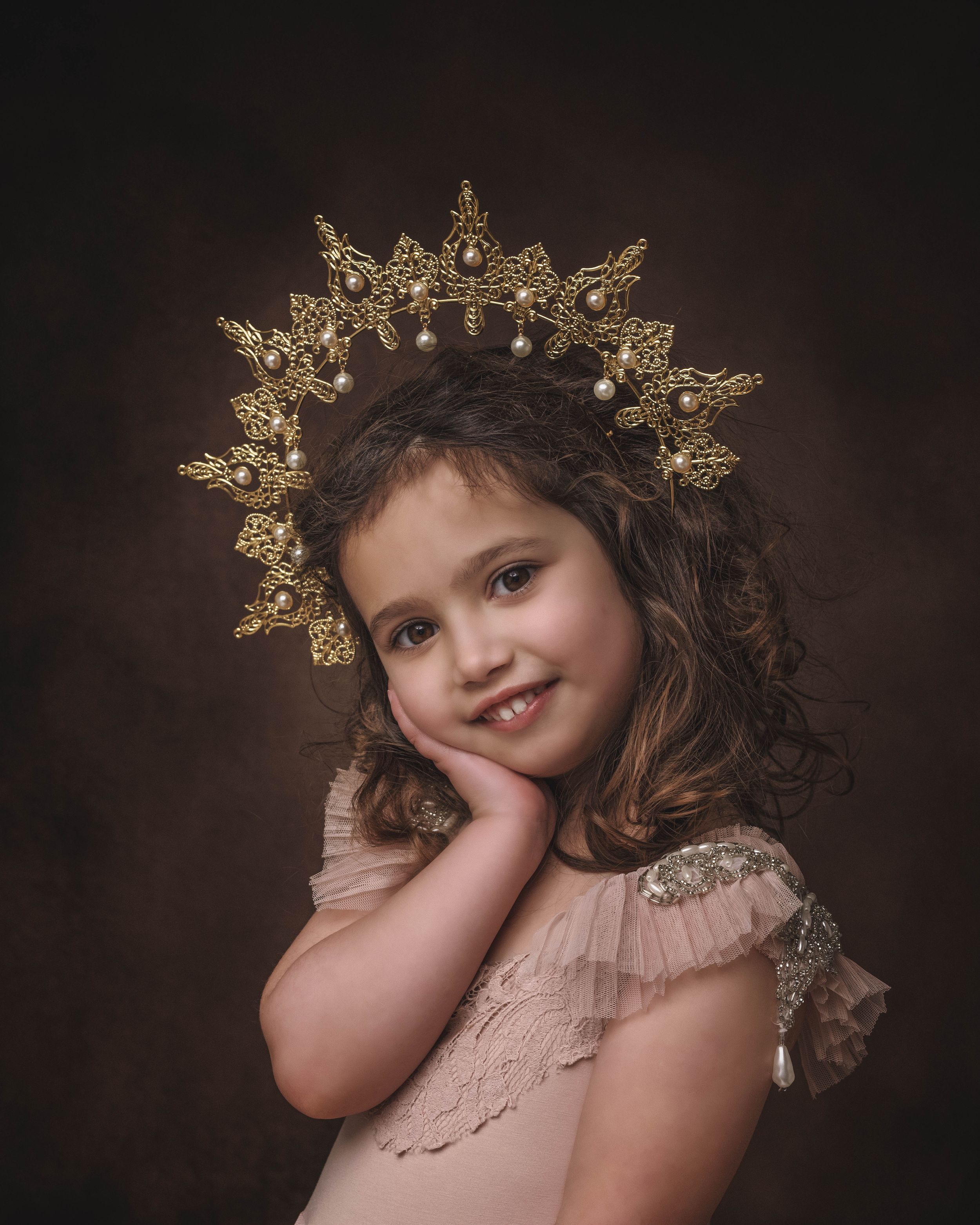 A maternity portrait in warm beige tones shows a person in a flowing dress with puff sleeves and a delicate crown-like headpiece.