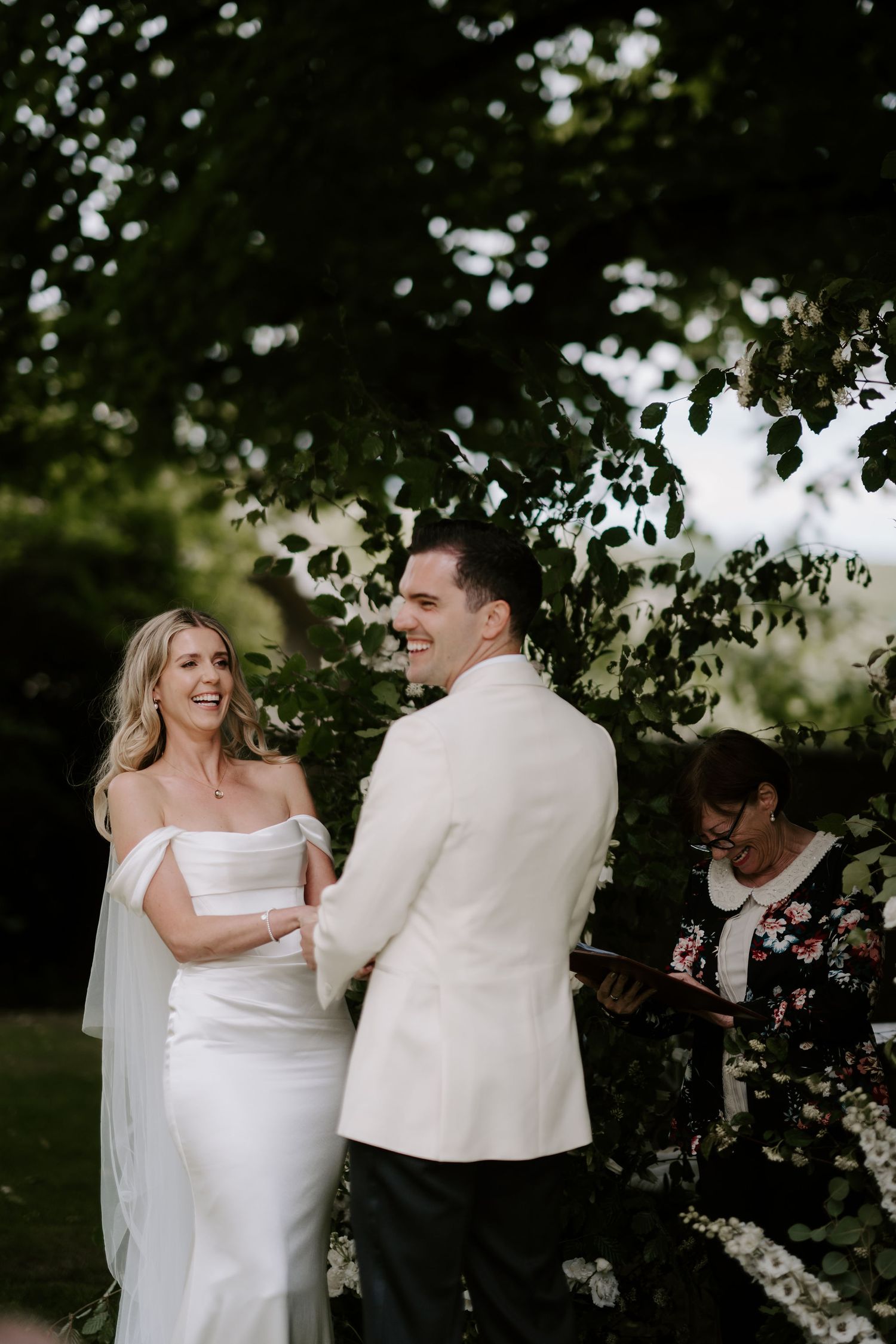 bride and groom holding hands and smiling during ceremony at Hamswell house in bath