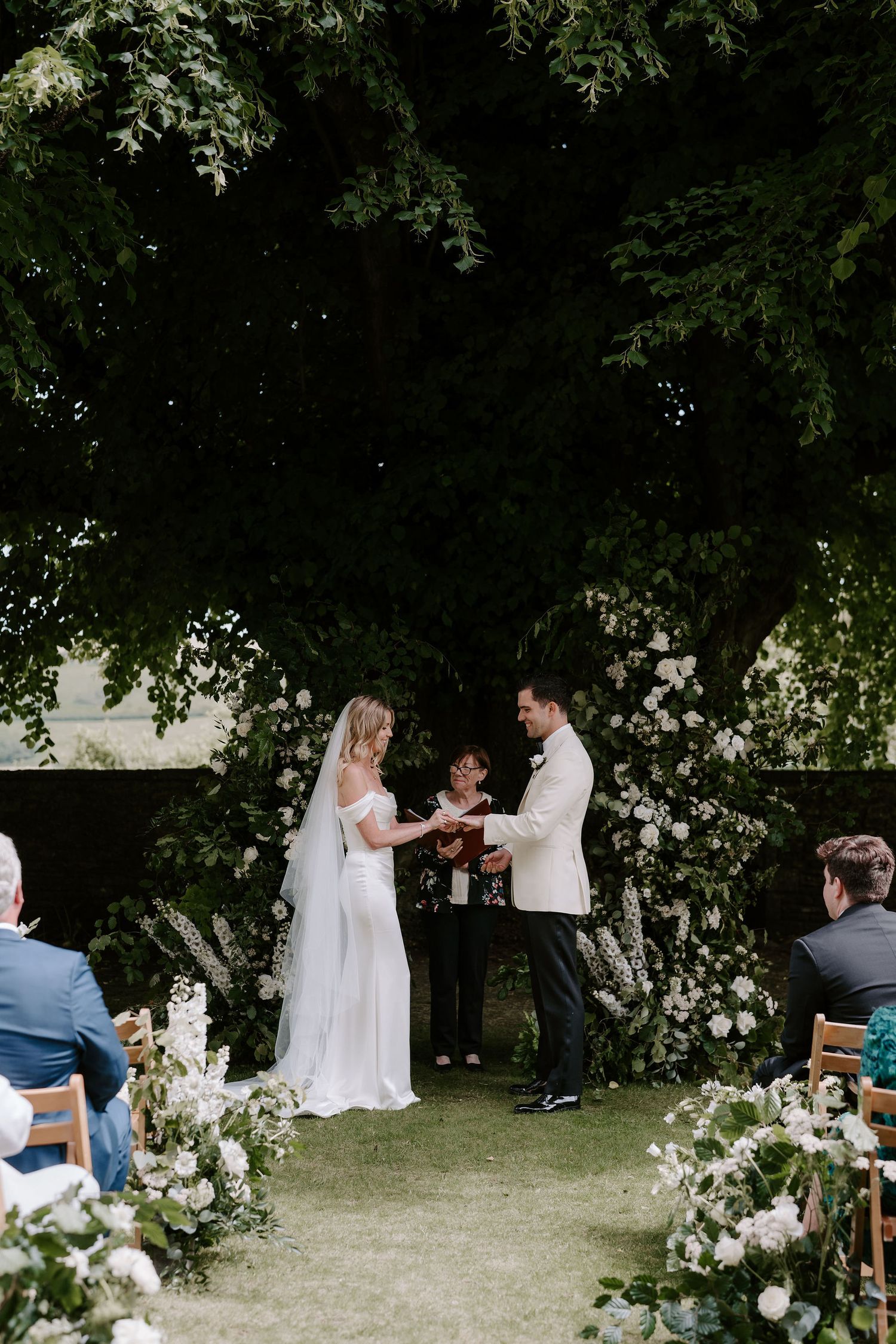 bride and groom exchanging wedding rings during ceremony at Hamswell house in bath