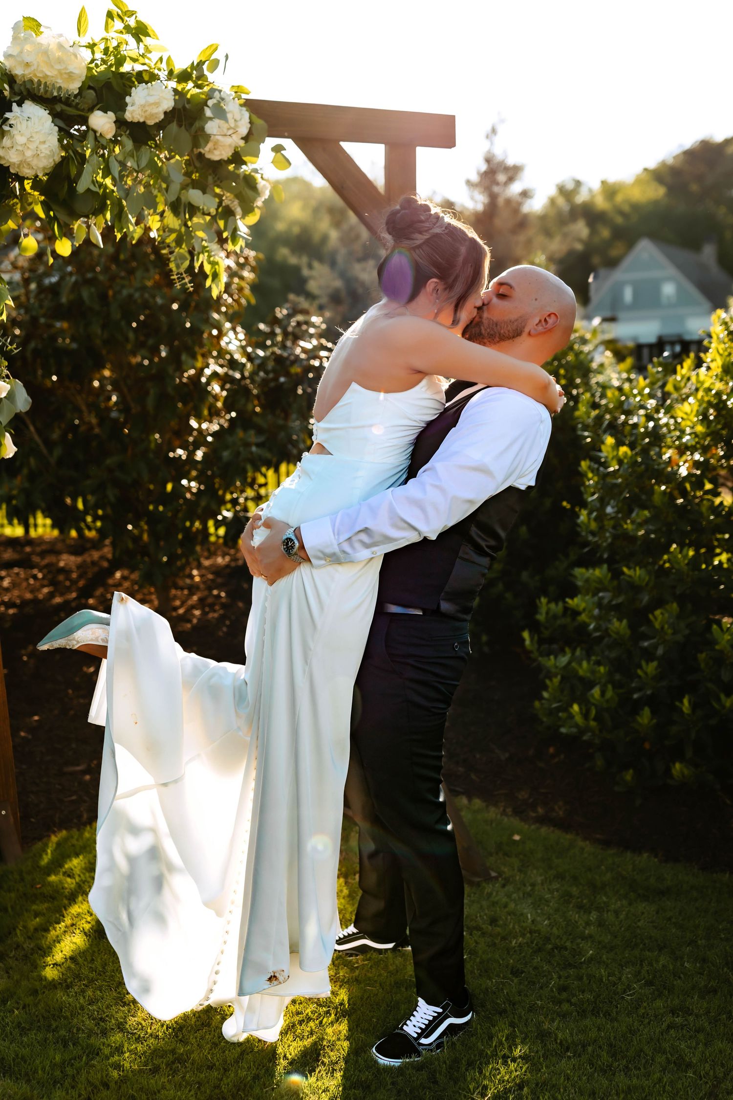 Romantic couple in casual white t-shirts and jeans sharing an intimate moment together in a modern kitchen.