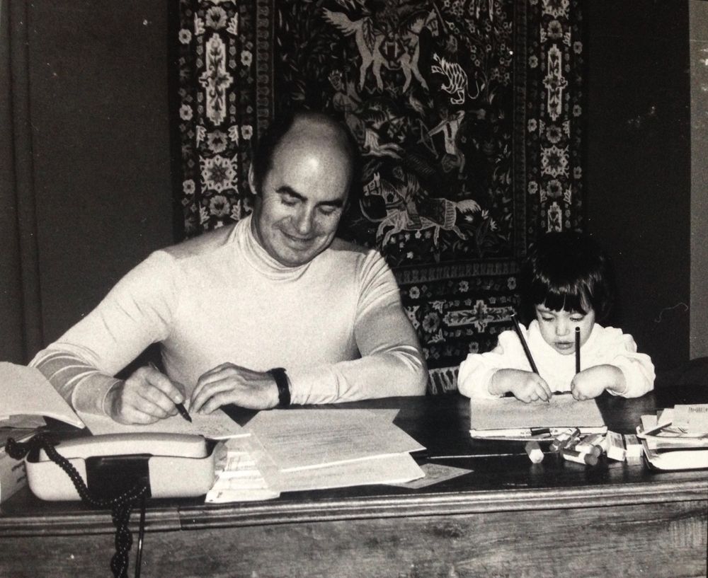 Black and white photograph of a study session at a desk with books and papers.