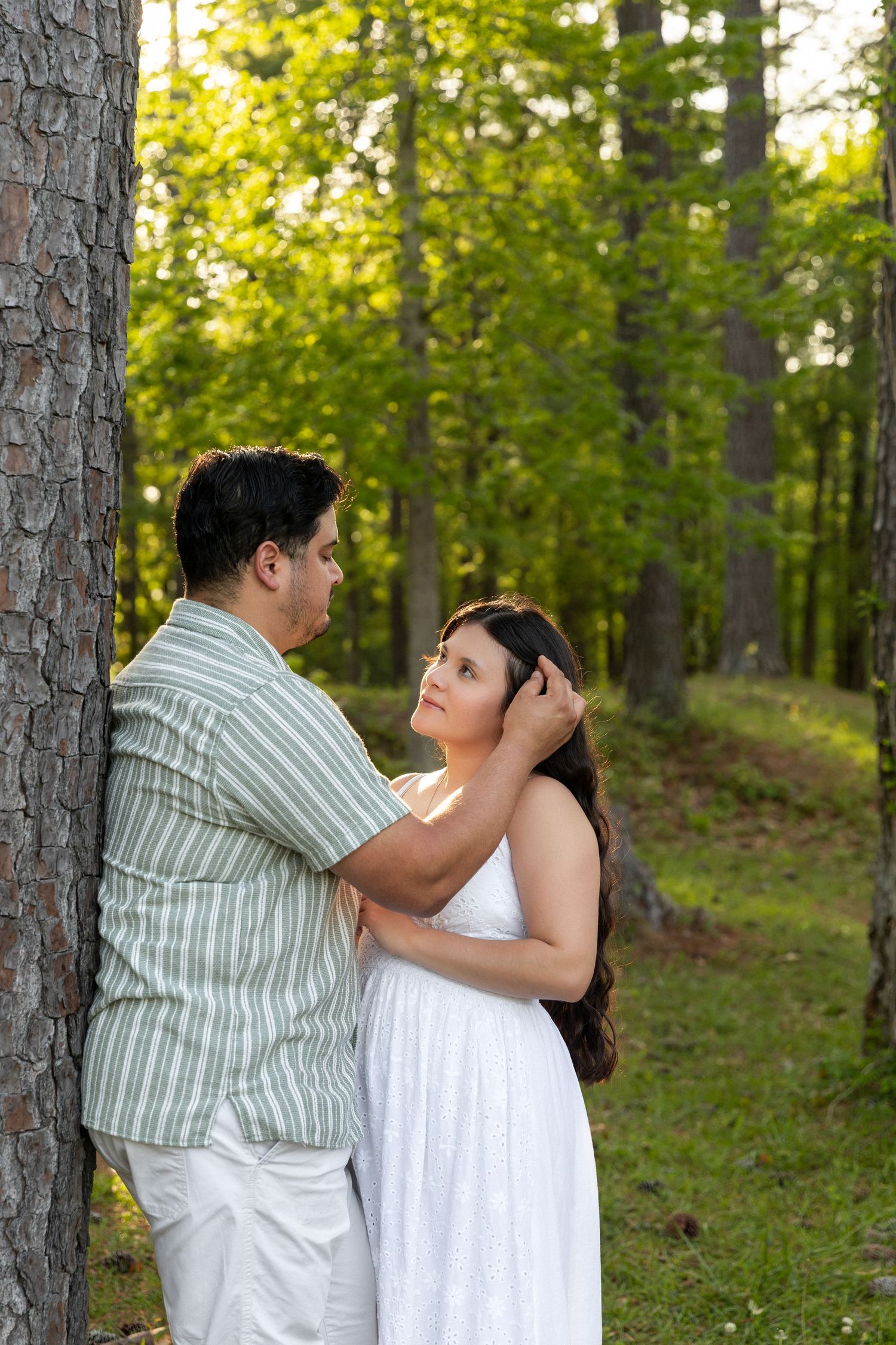 North Carolina couples session in a lush green forest in Jacksonville NC at sunset