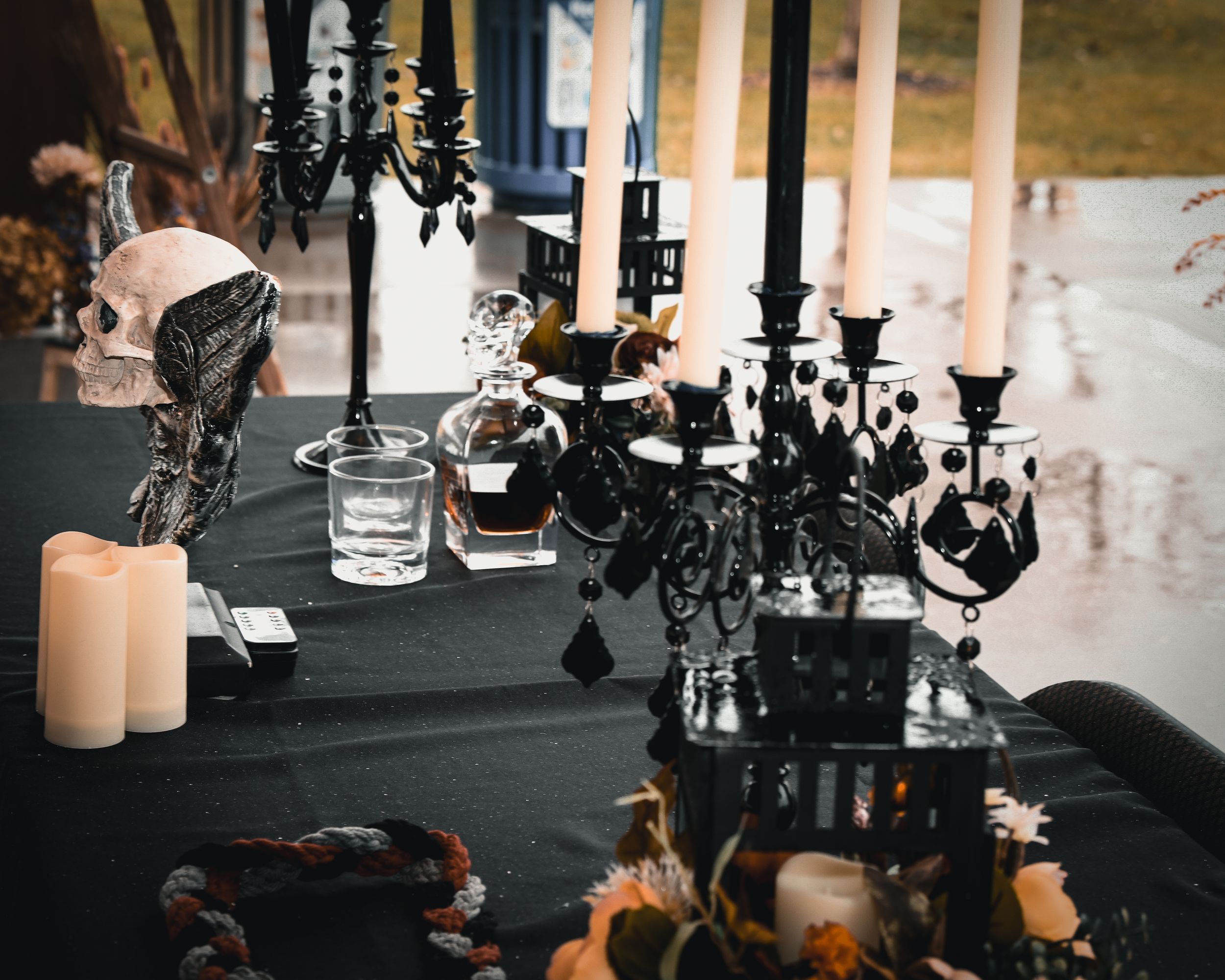 Gothic Halloween wedding table with black candelabras, skull decor, and dark floral arrangements.