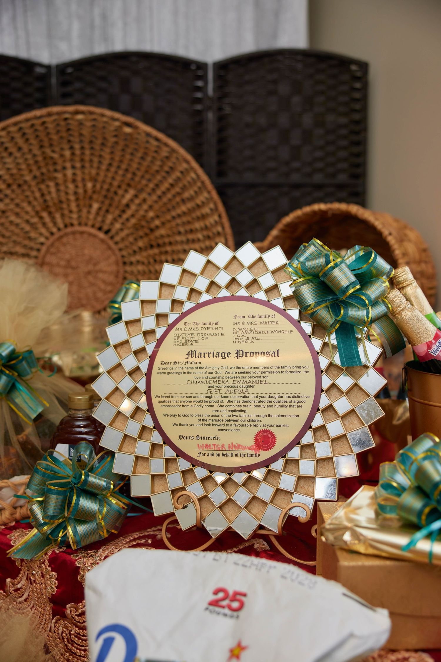Decorative circular Marriage Proposal document displayed with gift baskets, green ribbons, and woven trays at a traditional ceremony.