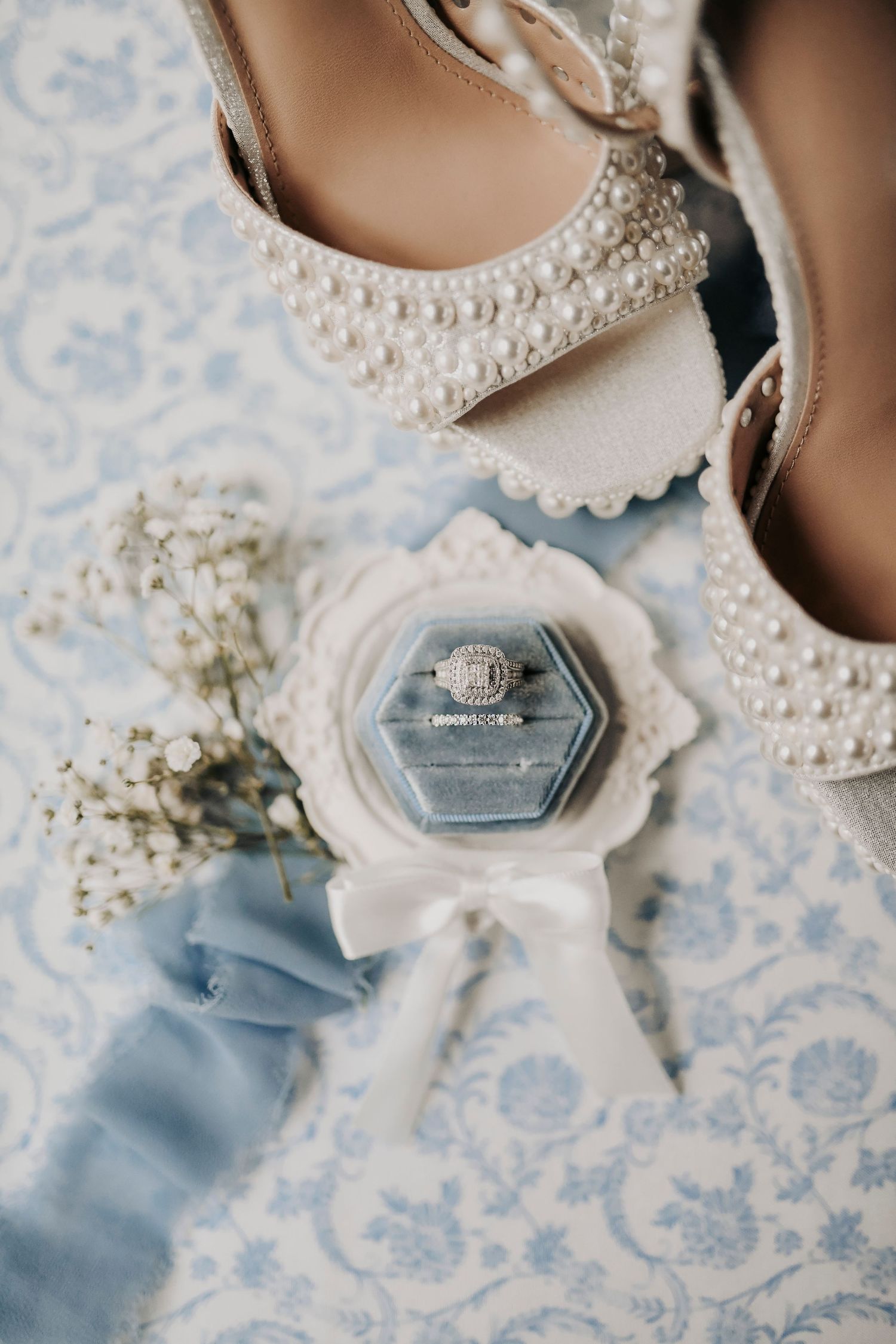 luxury wedding ring styling with floral accents and soft textures