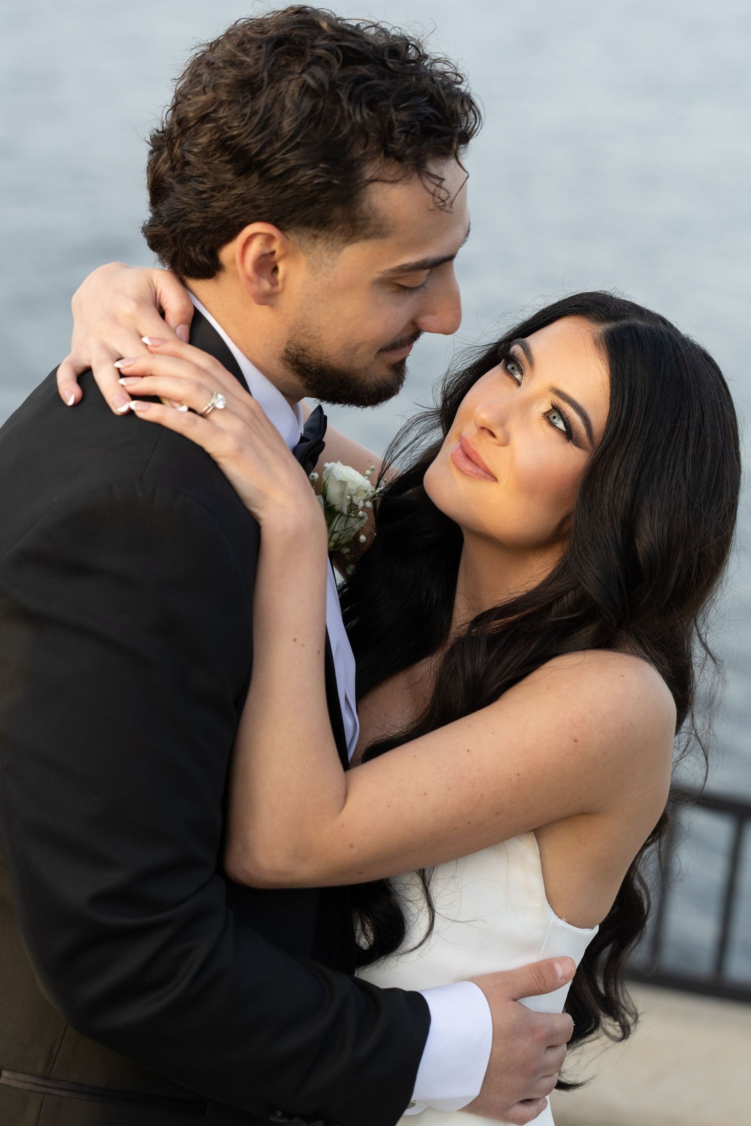 Close-up portrait of bride and groom during golden hour at Glen Island Harbour Club wedding venue.