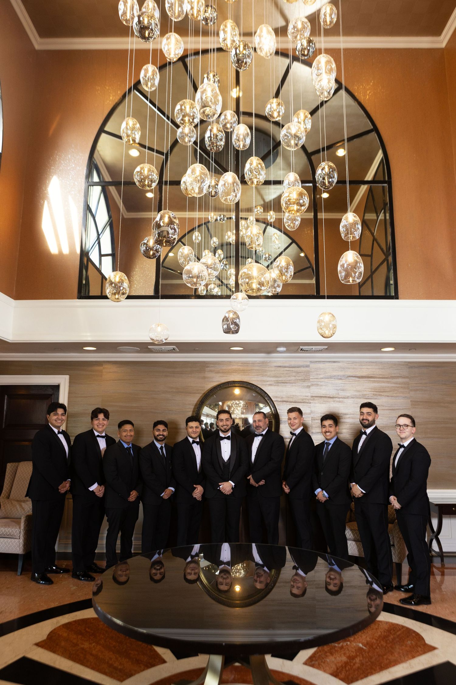 Groom and groomsmen posing before waterfront wedding at Glen Island Harbour Club.