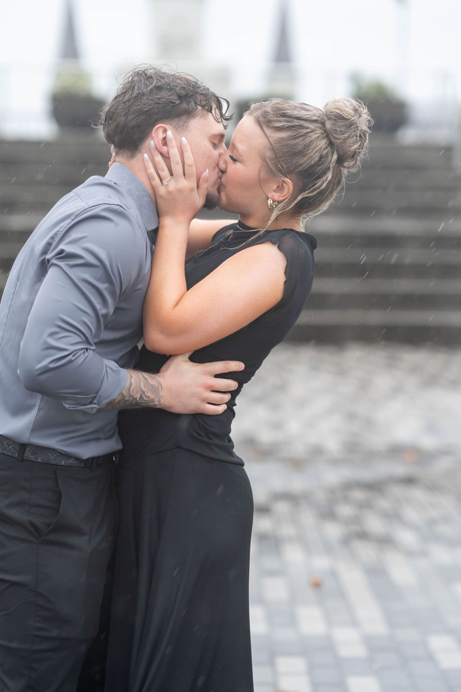 couple kisses in the rain