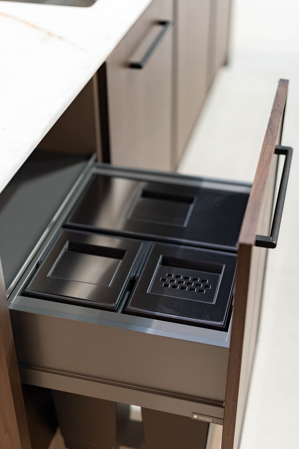 Close-up view of modern black cabinet drawer hardware with sleek geometric design details.