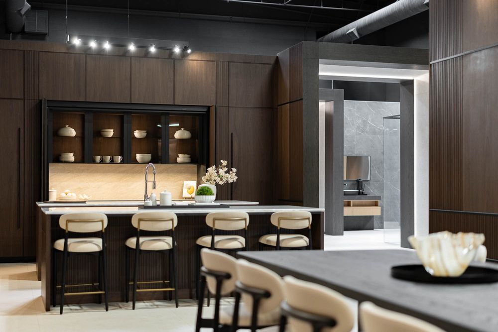 Contemporary dining space with dark wood paneling and recessed lighting creating an elegant atmosphere.