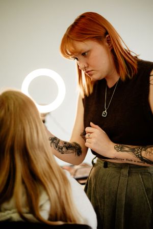 Wedding preparation scene with professional lighting equipment in the background.