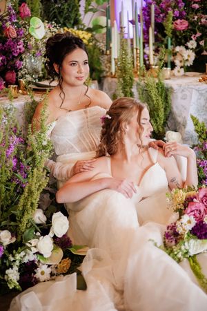 Wedding reception scene with romantic floral arrangements in purple and white.