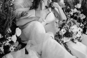 Delicate white roses and floral arrangements create an elegant wedding backdrop.