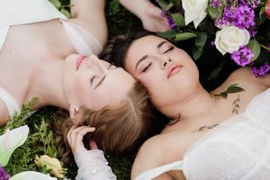 Dreamy floral photography setup with white and purple blooms.