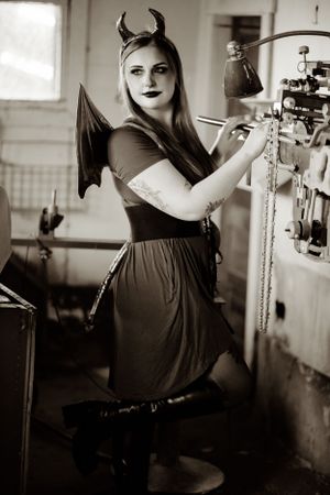 Black and white boudoir photoshoot featuring gothic style and dramatic poses.