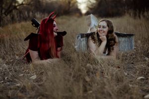 Artistic outdoor photography session with gothic themed props in tall grass.