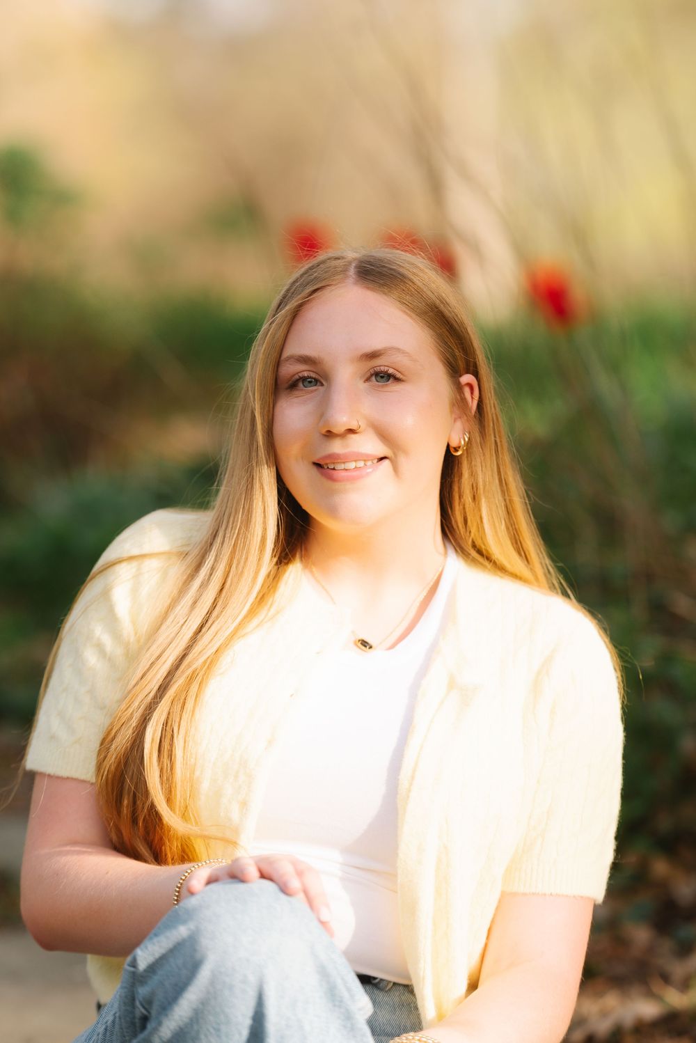 Portrait series of a person in white clothing sitting against a warm sunset backdrop with natural golden lighting.