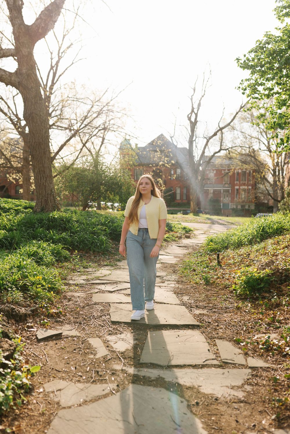 Collection of photos showing a yellow cardigan and jeans outfit in natural outdoor lighting on a stone path.