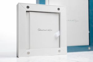 White paper storage boxes and organizers arranged neatly on white shelves against a blue wall.