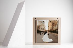 A series of wedding photos showing a white bridal gown against urban and indoor settings in soft, muted tones.